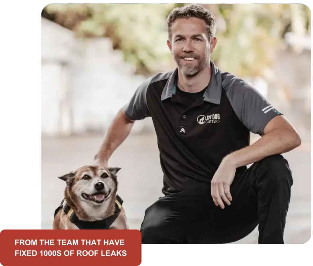 Sky Dog Gutter Care team member kneeling with the Sky Dog dog